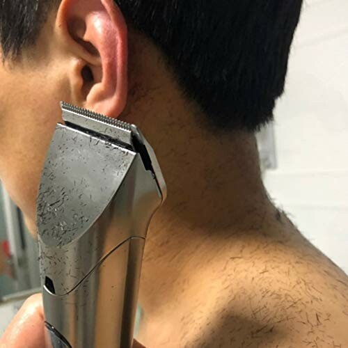 Close-up of a hair trimmer being used on a person's neck