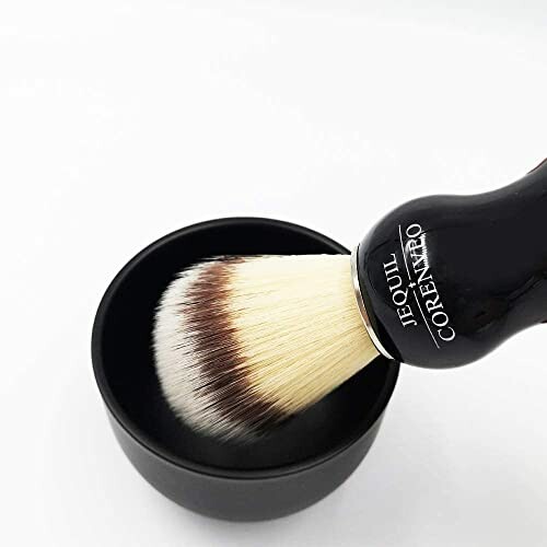 Shaving brush with black handle in a bowl